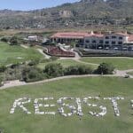 Flash mob spells out RESIST! at Trump National Golf Course