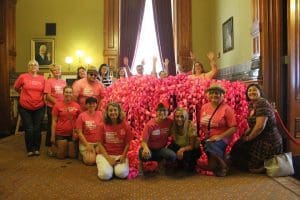 Planned Parenthood advocates deliver a paper chain of 14,600 links to Iowa Gov. Kim Reynolds.