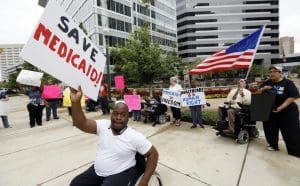 Medicaid recipients and their supporters stage a protest outside the building that houses the offices of Sen. Thad Cochran (R-MS)