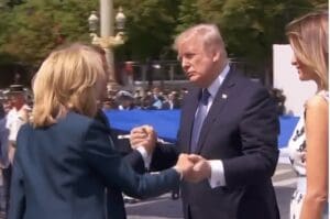 Trump has an extremely awkward handshake with the president and first lady of France.