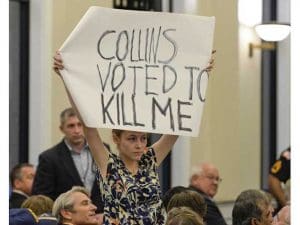 A protester at a town hall in the reddest district in the country, with a strong message