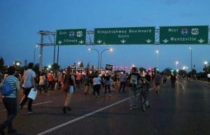 Protesters march down a highway in downtown St. Louis, after a judge found a white former police officer not guilty of first-degree murder in the death of a black man