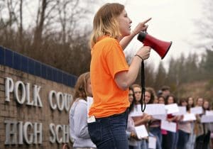 Around 50 Polk County High School students participated in a walk-out from school on Tuesday morning, February 20, 2018. The students, including senior Emily Hogan, center, protested the epidemic of mass shootings in American schools, speaking in front of the school's sign along Hwy. 108 in Columbus as supporters cheered them on.