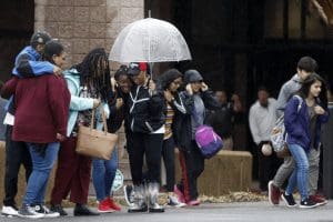 Students wait outside Dalton High School in Georgia after a shooting incident