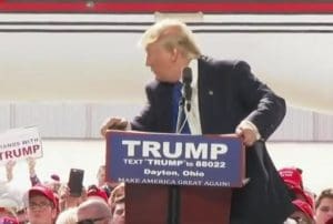 Donald Trump ducks as protester rushes stage at rally