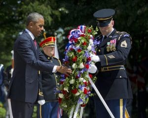 President Barack Obama and with the aid of Sgt. 1st Class John C. Wirth lays a wreath at the Tomb of the Unknowns, on Memorial Day, Monday, May 25, 2015, at Arlington National Cemetery