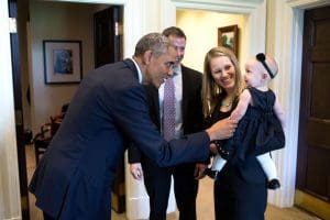 President Barack Obama greets departing staff member Lindsay Hayes and family in the Outer Oval Office