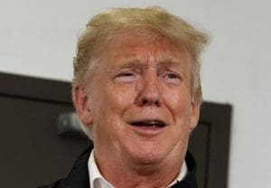 Trump laughs.