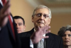 Mitch McConnell looks at Donald Trump