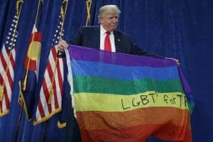 Donald Trump holds a rainbow flag.