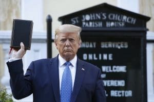 Donald Trump holds a bible.