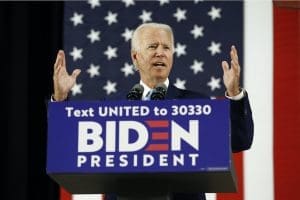 Joe Biden at podium with sign
