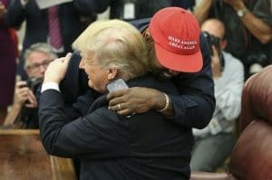 Donald Trump hugs Kanye West.
