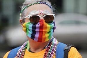 LGBTQ Pride marcher in rainbow mask in Seattle