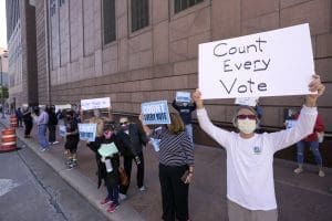 Protesters stand outside the federal courthouse in Houston, Texas, to call to count nearly 127,000 ballots from drive-thru polling places in Harris County.