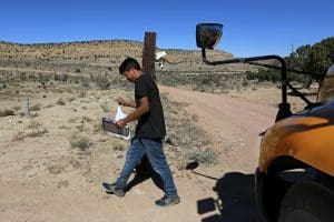 A student carries a book in rural New Mexico