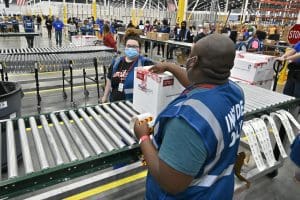 Warehouse workers load vaccines