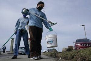 Volunteers clean PPE off beach