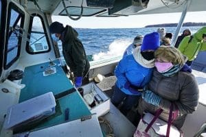 Nurses on a lobster boat delivering vaccines