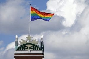 FILE - In this June 24, 2014 file photo, a giant Pride flag flies atop the Starbucks headquarters in celebration of Gay Pride Week in Seattle. More than 400 companies, including Starbucks, have signed on to support civil rights legislation for LGBTQ people that is moving through Congress, advocates said Tuesday, April 27, 2021. The Equality Act would amend existing civil rights law to explicitly include sexual orientation and gender identification as protected characteristics.