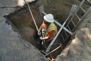 Worker removes lead pipe in Denver