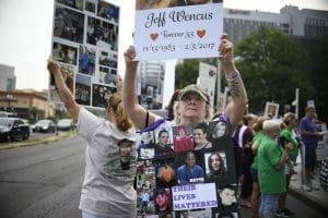 People protesting against Purdue Pharma opioid settlement