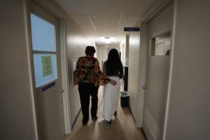 Abortion clinic worker escorts patient