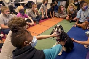 School children with therapy dog