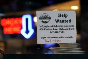 Sign reading "Help Wanted - leftyspizzakitchen@gmail.com 600 Central Ave. Highland Park, IL 847-926-7194 - night and weekend shifts available (Part-time)"is displayed in a window of a restaurant in Highland Park, Illinois