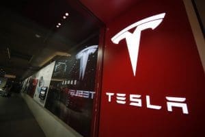 A sign bearing the company logo outside a Tesla store in Cherry Creek Mall in Denver is seen here on Feb. 9, 2019.
