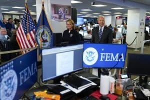 President Joe Biden arrives with FEMA Administrator Deanne Criswell to participate in a briefing about the impact of Hurricane Ian during a visit to FEMA headquarters, Thursday, Sept. 29, 2022, in Washington. (AP Photo/Evan Vucci)