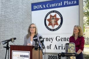 Arizona Secretary of State Latie Hobbs, left, the Democratic nominee for governor, and Kris Mayes, a Democrat running for attorney general, speak to reporters outside the Arizona Attorney General's Office in Phoenix on Saturday, Sept. 24, 2022.