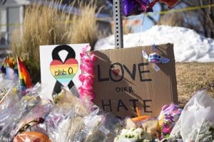Bouquets of flowers sit on a corner near the site of a mass shooting at a gay bar Monday, Nov. 21, 2022, in Colorado Springs, Colo. Club Q on its Facebook page thanked the "quick reactions of heroic customers that subdued the gunman and ended this hate attack.”