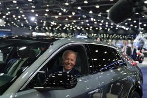 President Joe Biden drives a Cadillac Lyriq through the showroom during a tour at the Detroit Auto Show, Sept. 14, 2022, in Detroit.