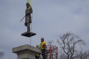 The bronze statue of Lieutenant General A.P. Hill is removed from its pedestal on Monday Dec. 12, 2022 in Richmond, Va.