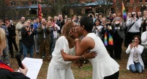 Yashinari Effinger kisses her spouse Adrian Thomas as they are declared a married couple by Rev. Ellin Jimmerson, minister to the community from Weatherly Baptist Church, Monday, Feb. 9, 2015 in Big Spring Park in Huntsville, Ala. Gay couples began getting married in Alabama on Monday morning, despite an 11th-hour attempt from the state's chief justice, an outspoken opponent of same-sex marriage, to block the weddings.