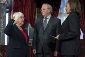 Vice President Kamala Harris participates in a ceremonial swearing-in of Sen. Patty Murray as president pro tempore, with Murray's husband Rob Murray by her side, on Jan. 3, 2023.