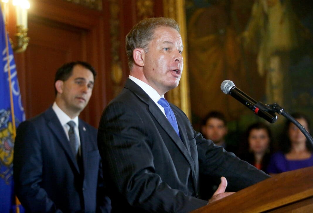 Then-lawyer Daniel Kelly speaks during a press conference at the Wisconsin State Capitol in Madison, Wis. after being appointed to the state Supreme Court by Governor Scott Walker, left, Friday, July 22, 2016.