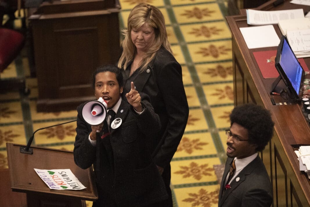 Tennessee state Rep. Justin Jones calls on his colleagues to pass gun control legislation alongside Reps. Gloria Johnson and Justin Pearson during the legislative session at the State Capitol on March 30, 2023.