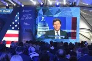 American media personality Tucker Carlson appears on the screen during the opening session of Hungary Conservative Political Action Conference in Budapest, Hungary, Thursday, May 4, 2023. The two-day CPAC meeting organized by Center for Fundamental Rights of Hungary features some 60 prestigious foreign speakers from 20 countries and five continents.