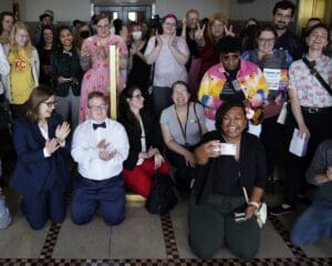 Supporters of a resolution that would make Kansas City, Missouri, a sanctuary city for transgender people celebrate outside of city council chambers after a committee approved the resolution on Wednesday, May 10, 2023.