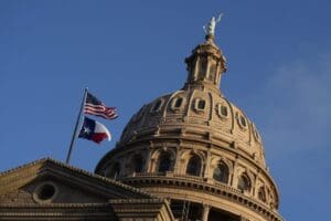 The U.S. and Texas flags fly over the Texas Capitol during the first day of the 88th Texas Legislative Session in Austin, Texas, Tuesday, Jan. 10, 2023.