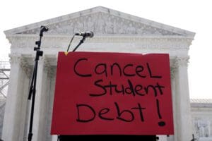 A sign reading "cancel student debt" is seen outside the Supreme Court, Friday, June 30, 2023, in Washington.