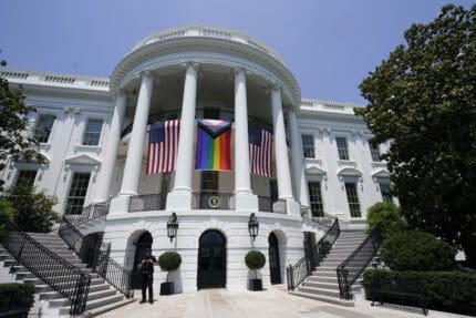 American flags and a pride flag hang from the White House during a Pride Month celebration on the South Lawn, Saturday, June 10, 2023, in Washington.