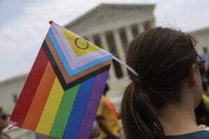 A demonstrator holds an Intersex-inclusive Pride Flag during a press conference outside of the Supreme Court in Washington, D.C. on June 30, 2023.