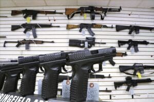 Semi-automatic guns are displayed for sale at Capitol City Arms Supply, Jan. 16, 2013, in Springfield, Ill.