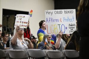 Parents, students, and staff of Chino Valley Unified School District hold up signs in favor of protecting LGBTQ+ policies at Don Antonio Lugo High School, on June 15, 2023, in Chino, Calif.