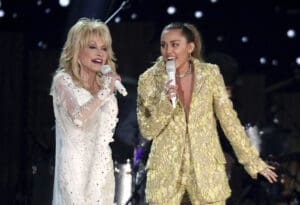 Dolly Parton, left, and Miley Cyrus perform 