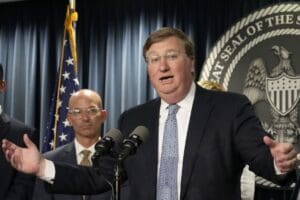 Mississippi Gov. Tate Reeves, right, announces a proposal that he says should alleviate financial problems for hospitals, during a news conference Thursday, Sept. 21, 2023, in Jackson, Miss. (AP Photo/Rogelio V. Solis)